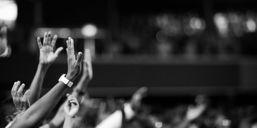 grayscale photography of hands waving